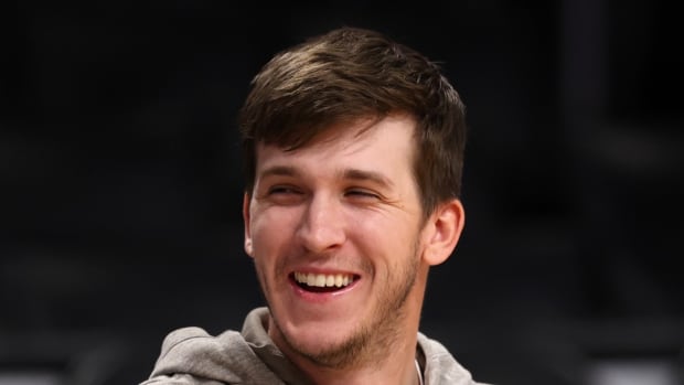 Mar 8, 2024; Los Angeles, California, USA; Los Angeles Lakers guard Austin Reaves (15, right) smiles on the bench prior to the game against the Milwaukee Bucks at Crypto.com Arena. 